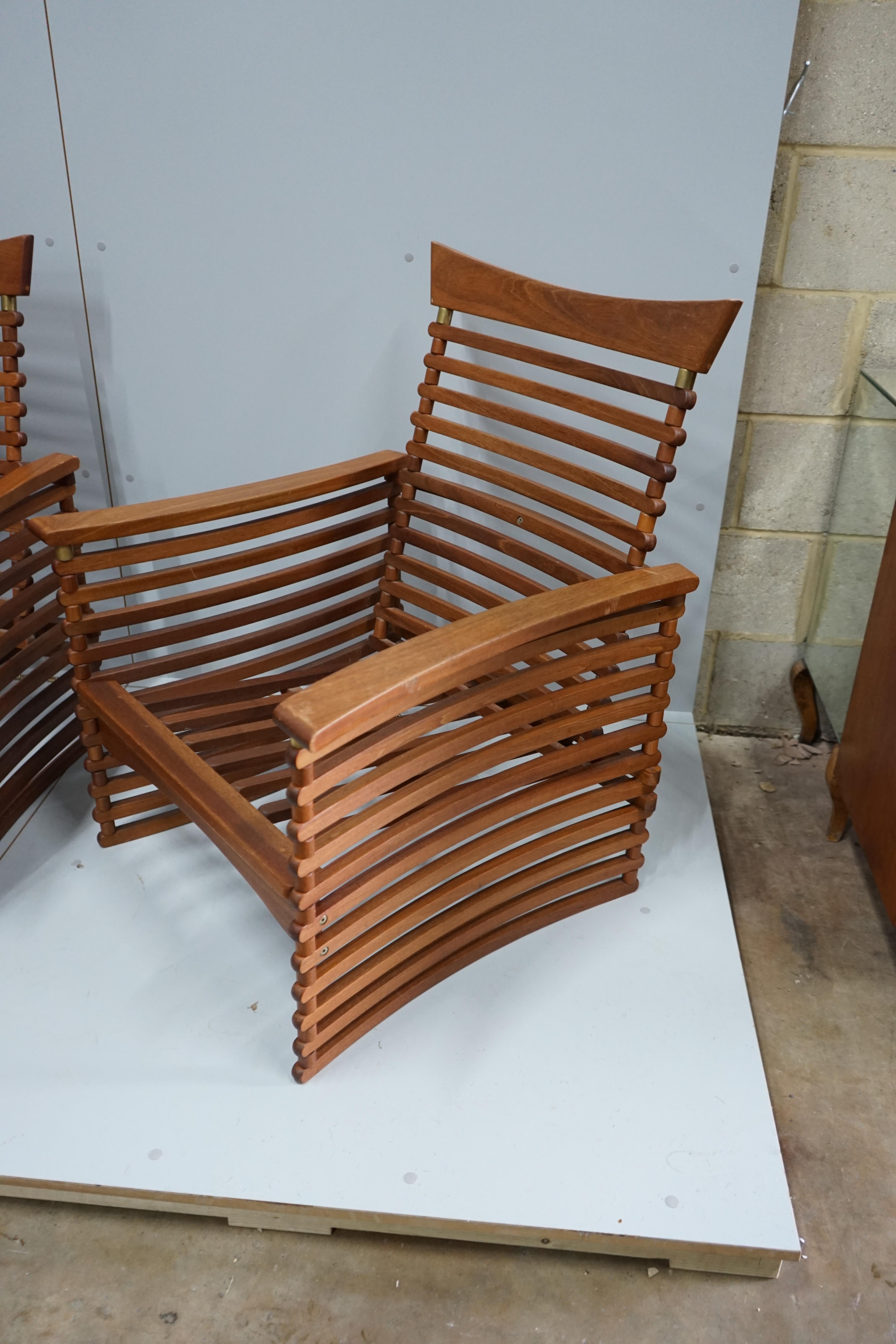 In the manner of Finn Juhl, a Danish brass mounted teak three piece lounge suite of slatted form, settee width 143cm, depth 77cm, height 92cm.